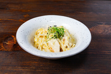 Culinary delight featuring creamy pasta with fresh herbs Savory vegetable pie served with fresh garnishes