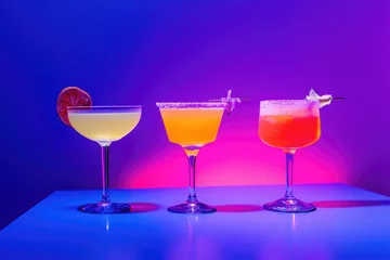 Three vibrant cocktails presented in ultraviolet style with creative lighting and stark compositions