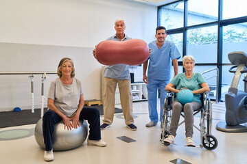 Group in a senior rehab facility exercising with assistance from a therapist