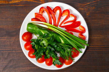 Fresh vegetables arranged on a plate for healthy meal preparation Savory vegetable pie served with fresh garnishes