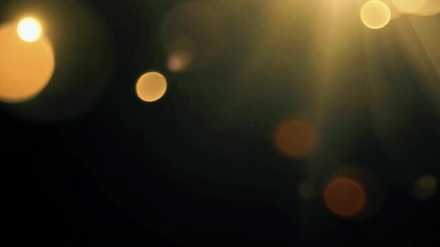 Golden Lens Flare with Bokeh Effect on Black Background