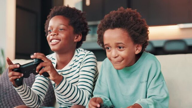 Gaming, video games and children on sofa in home for entertainment, online fun and esports. African family, siblings and kids with controller for virtual media, playing and bonding in living room