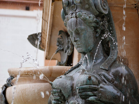 A sculpture of lactating Nereid as a part of The Fountain of Neptune in Bologna, Italy