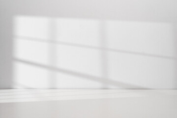 Sunlight coming through the window on the white wall background with copy space