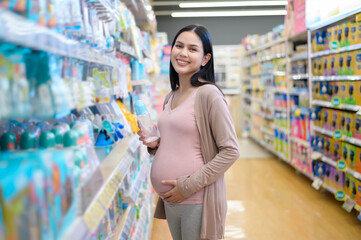 Pregnant woman shopping newborn products in the mall