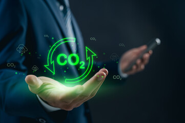 Executive exploring advanced CO2 reduction techniques and sustainability initiatives using digital interface, aimed at environmental conservation