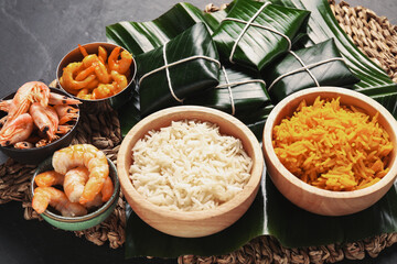Cut banana leaves with different food on dark table, closeup. Healthy eco serving