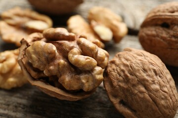 Fresh walnuts with shells on table, closeup