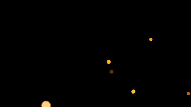 Abstract video with a top-down angle, featuring soft-focus bokeh lights against a dark background, creating a dreamy, atmospheric effect.