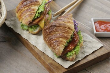 Closeup of Delicious Croissant Sandwich on Wooden
