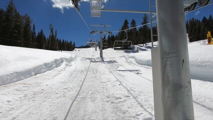 Winter Landscape With Ski Lift Ascending On A Snow-covered Hill Under A Clear Sky