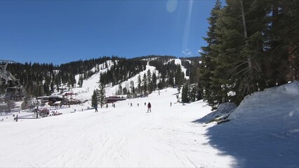 Active Group Of People Enjoying Winter Sport, Skiing Down A Snow-covered Mountain Slope