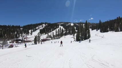 Enthusiastic Crowd Partaking In Winter Skiing Activities Down A Pristine Snow-covered Slope