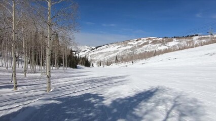 Scenic View Of A Perfectly Groomed Snow Covered Ski Slope On A Winter Day