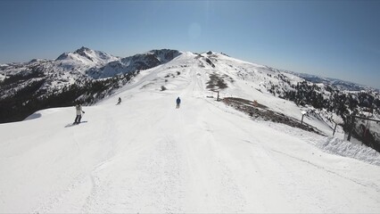 Adventurous Skier Descending A Snow Covered Mountain On A Clear Winter Day