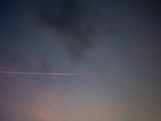 contrails in the purple evening sky