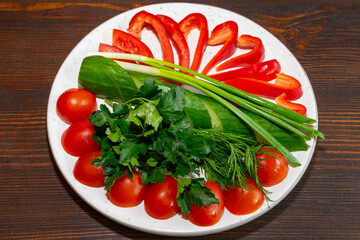 Freshly cut vegetables arranged beautifully on a white plate Savory vegetable pie served with fresh garnishes