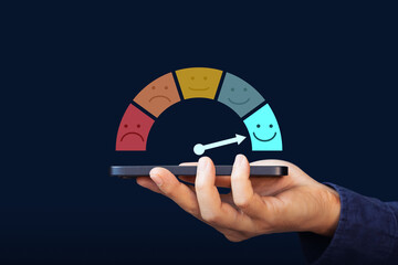Excellent, positive feedback, service rating and satisfaction. A man holding mobile phone with rating feedback scale indicates the highest level of satisfaction with the service