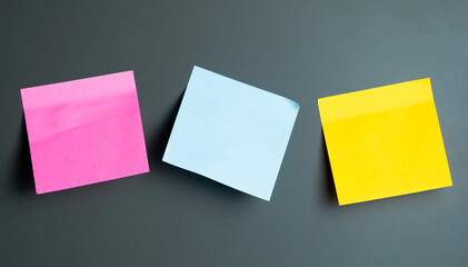 Colorful sticky notes arranged on a dark surface