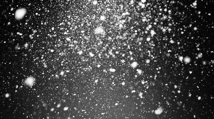Obraz premium Dramatic flurry snowfall on a black backdrop for impactful design