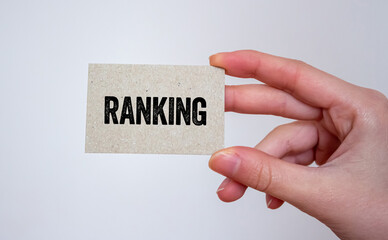 Ranking message written on a card in hand. Conceptual ranking symbol. Copy space.