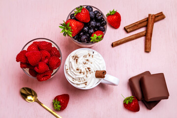 Healthy and delicious desserts with fruits in a beautiful composition on a pink pastel background.