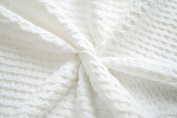 Obraz premium Textured organic cotton fabric, soft with visible stitching and natural imperfections, perfect for eco-friendly designs.