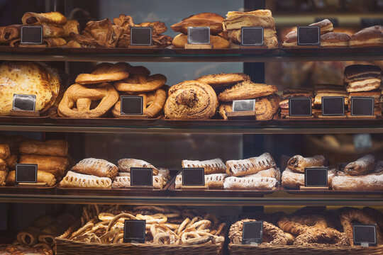 Artisan bakery display filled with freshly baked breads and pastries in a cozy café setting - Powered by Adobe