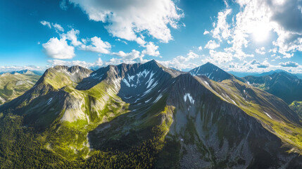 Fototapeta premium A panoramic aerial view of mountain peaks blanketed in deep green coniferous forests, bathed in sunlight under a bright blue sky