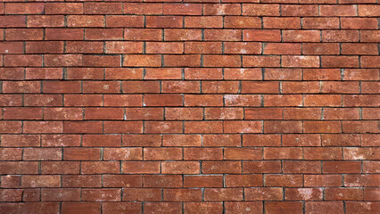 Obraz premium A brick wall with a red color. The wall is made of bricks and has a rough texture