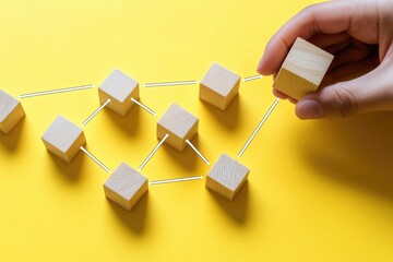 A person holds a wooden block in front of multiple wooden blocks, creative learning aid for kids