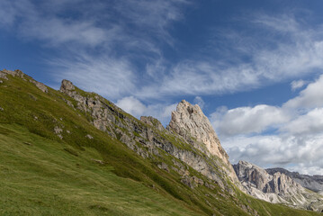 Expansive shot of the iconic Seceda plateau meadow in Italy’s Dolomites, showcasing lush green hills and dramatic rocky peaks