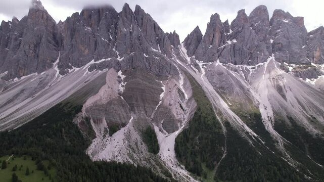 DRONE AERIAL FOOTAGE - The Odle Group is an impressive mountain range in the Dolomites, Bolzano, Trentino Alto Adige, Italy. The main peak of this massif is Mt. Sass Rigais.