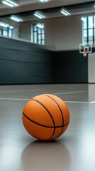 Fototapeta premium Basketball on the court in a modern indoor gym during daylight, inviting practice and training sessions for players of all levels