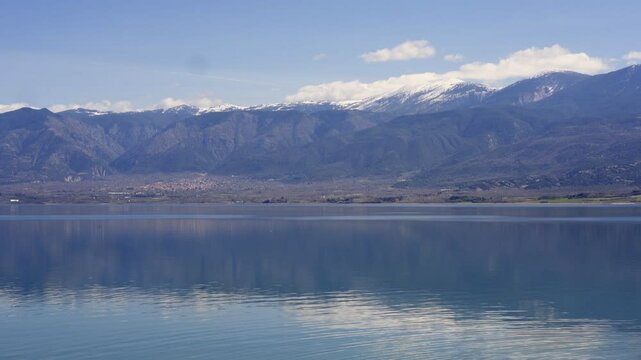 Lake Polyfyto mountain landscape view with snow on the peaks in Greece
