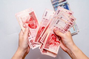 Holding New Taiwan Dollar, Taiwan banknote, symbol of wealth and success