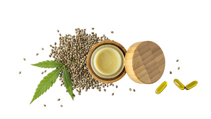 Cannabis balm in glass bamboo jar, CBD oil capsule, hemp seeds and leaf isolated on white background. Salve for joints and muscles and relaxing oil as complex in treatment.