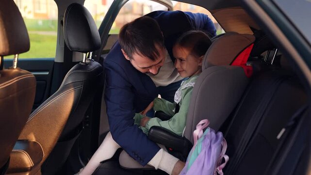 man unfastens seat belt. get child car. leather rear seats. child safety car traveling. car happy family. parent with child lead daughter girl car. happy family concept. Kid schoolgirl loves father.
