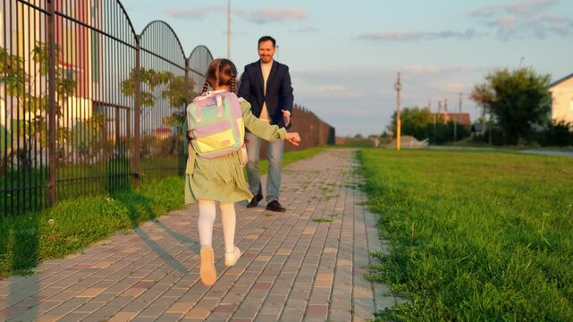 child with school backpack runs into hands his father, school lesson education, daddy care, child hugs his father, child kid daughter flight, playing superhero, happy hug flight, father day, dad