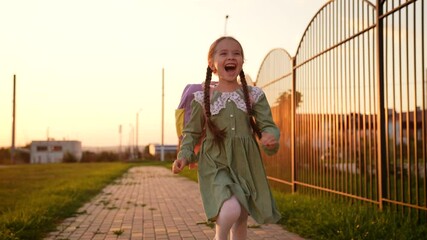 happy child with school backpack runs along way school, children education, child smile laughter, first-grader kid with bag runs happily through school yard, child smile with teeth, kid laughter