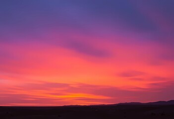 Fototapeta premium Vibrant Sunset Hues Over a Serene Landscape