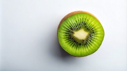 A vibrant, halved kiwi fruit on a pristine white background, showcasing its bright green flesh and tiny black seeds.