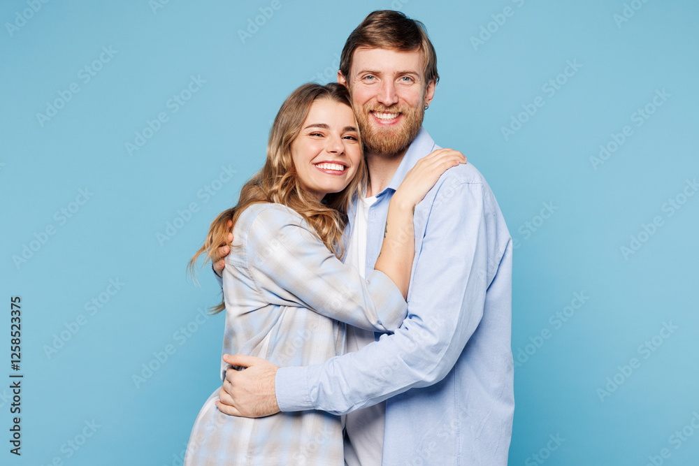 Sticker Side profile view young couple two friends family man woman wearing shirt casual clothes cuddle embrace together isolated on pastel plain light blue cyan background studio portrait. Lifestyle concept.