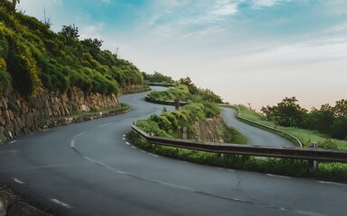 A photo of a winding road leading up a hill, with a view of the surrounding landscape.