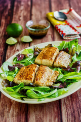 seared grouper on a bed of mixed greens