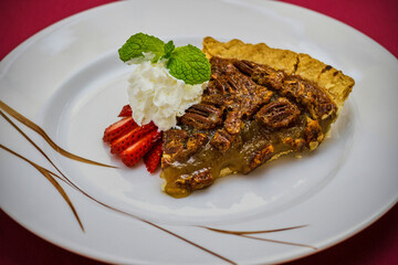 slice of southern pecan pie with fresh fruit and whipped cream