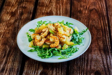 spicy tropical shrimp made with garlic and pineapple, served on a bed of mixed greens