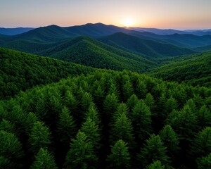 Fototapeta premium Breathtaking aerial view of lush green mountains at sunset with vibrant sky colors.