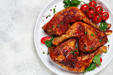grilled fried chicken legs, served, with fresh cherry tomatoes, and herbs, on a white plate, homemade, no people,