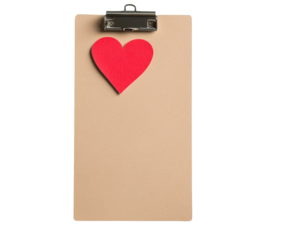 blank clipboard with red heart shaped sticker attached, symbolizing love and care